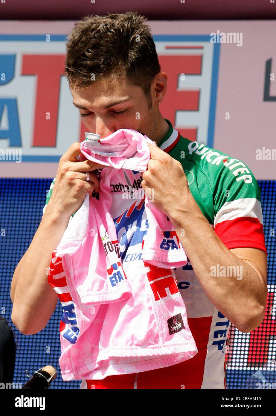 Italy's Giovanni Visconti kisses the leader's pink jersey on the podium after the sixth stage of the Giro d'Italia cycling race 232-km from Potenza to Peschici May 15, 2008.  REUTERS/Giampiero Sposito (ITALY) Stock Photo