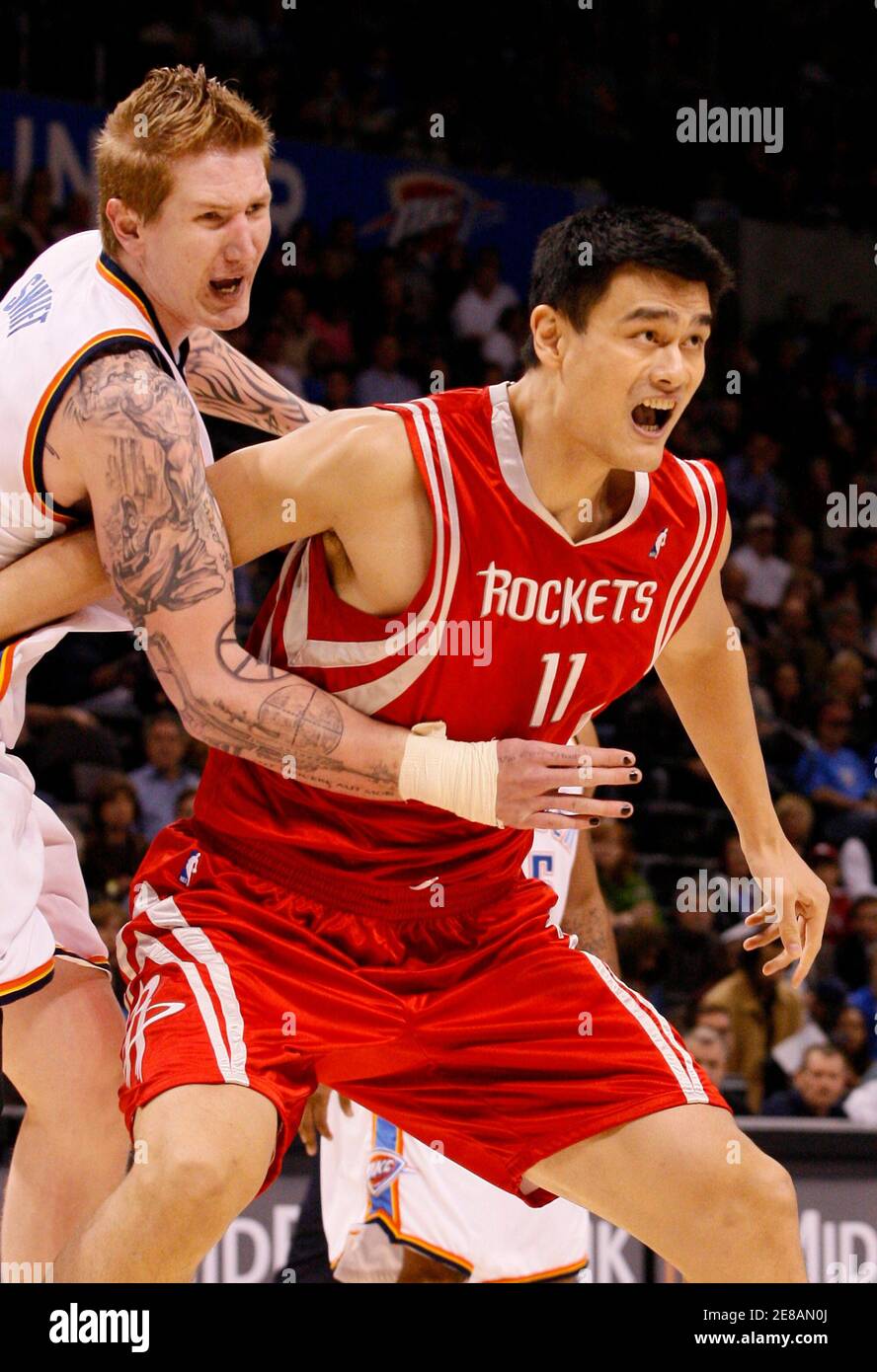 Houston Rockets center Yao Ming of China (R) fights the defense of Oklahoma  City Thunder center Robert Swift in the first quarter of their NBA  basketball game in Oklahoma City November 17,
