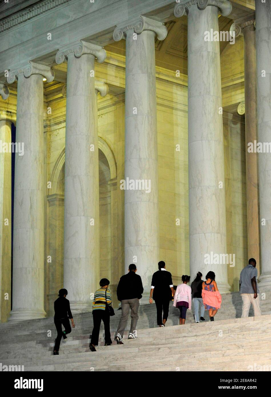 U.S. President Barack Obama (3rd L) walks with family members up the steps for a night time visit to the Jefferson Memorial on the Tidal Basin in Washington September 27, 2009. First lady Michelle Obama (5th R) walks with daughter Sasha (4th R) and niece Suhaila Soetoro-Ng (2nd R) as Michelle's mother Marian Robinson (2nd L) and daughter Malia (L) follow. Secret Service agents are at (R) and (3rd R).          REUTERS/Mike Theiler (UNITED STATES POLITICS) Stock Photo