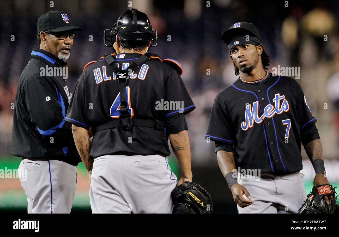 New York Mets manager Jerry Manuel (L) waits on the mound during another Mets pitching change in the eighth inning of their MLB National League baseball game in Washington May 19, 2010. Catcher Henry Blanco (C) and shortstop Jose Reyes (R) join Manuel.     REUTERS/Gary Cameron     (UNITED STATES - Tags: SPORT BASEBALL) Stock Photo