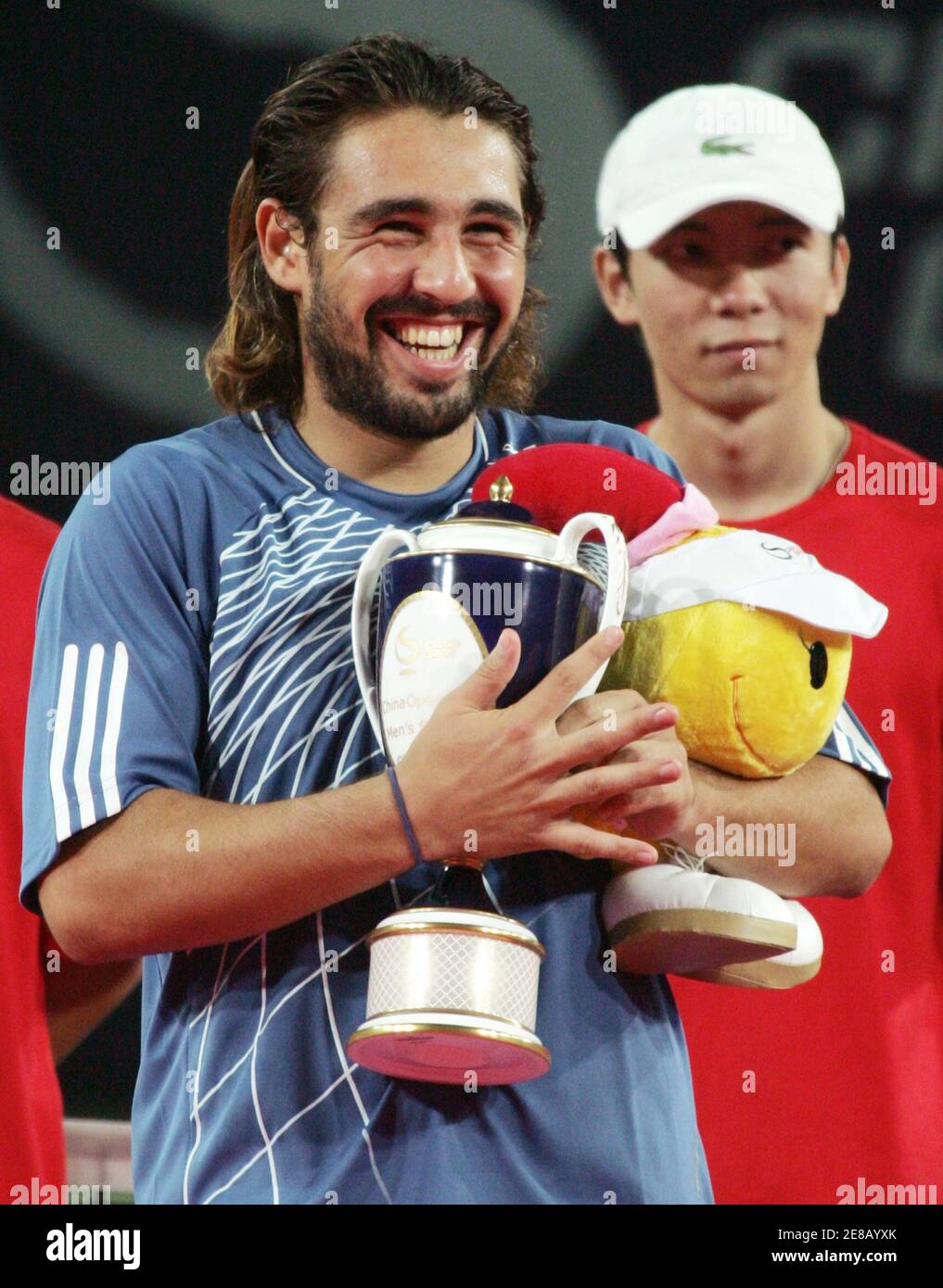 Marcos Baghdatis of Cyprus smiles as he holds the China Open trophy during a prize presentation ceremony at the Beijing Tennis Centre in Beijing September 17, 2006. Baghdatis won his first ATP title with a 6-4 6-0 victory over Croatian Mario Ancic at the China Open on Sunday.     REUTERS/Jason Lee (CHINA) Stock Photo