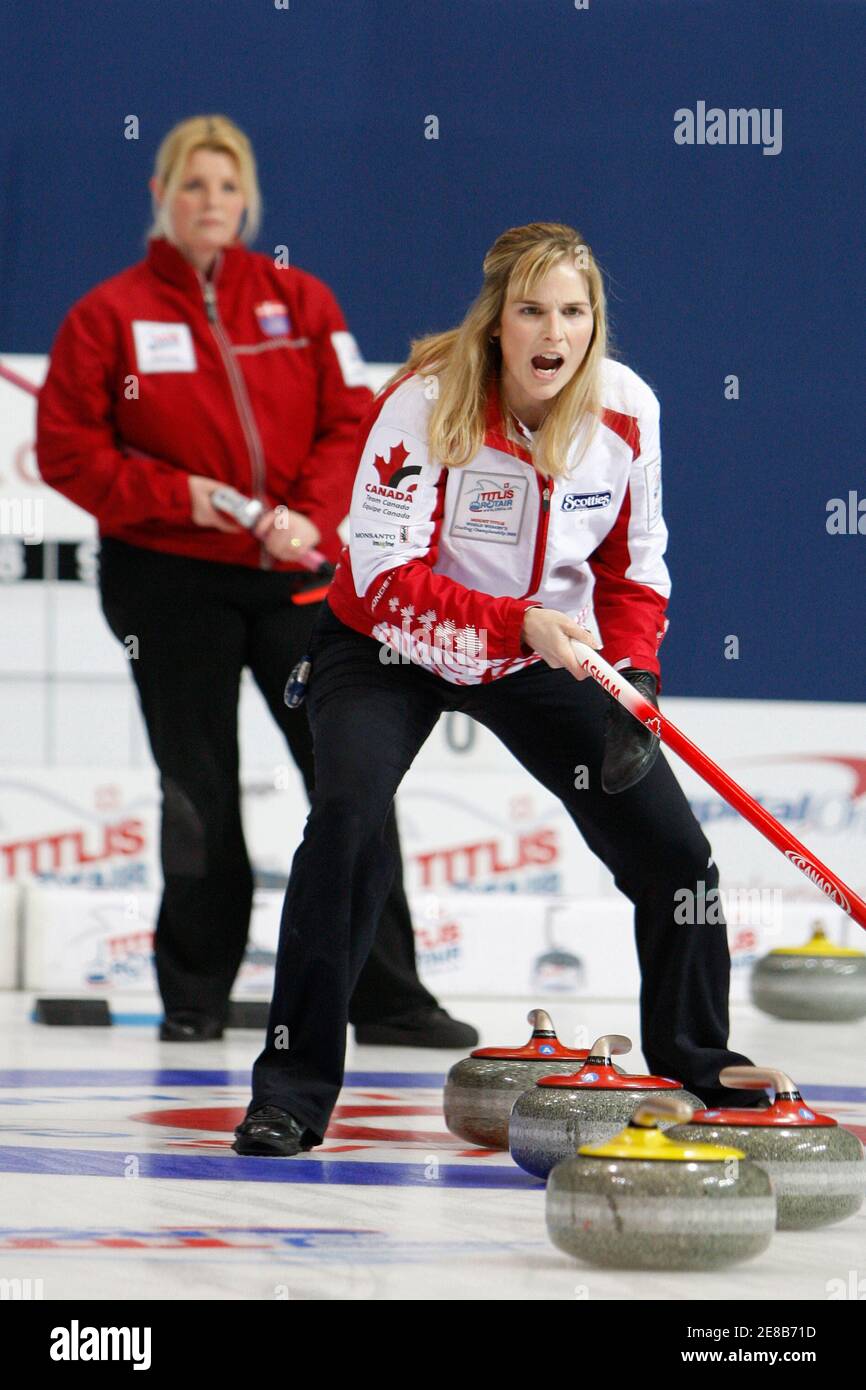 Team Canada skip Jennifer Jones (front) watches the line of a stone as team  Denmark skip Angelina Jensen looks on during their bronze medal match at  the 2009 World Women's Curling Championship