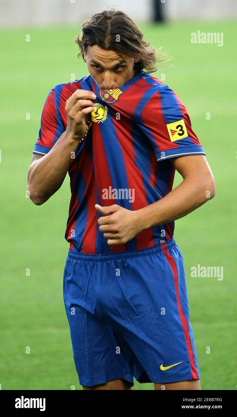 Barcelona's new signing Zlatan Ibrahimovic of Sweden kisses his new FC  Barcelona jersey as he was presented at the Camp Nou stadium in Barcelona  July 27, 2009. Inter have agreed to swap