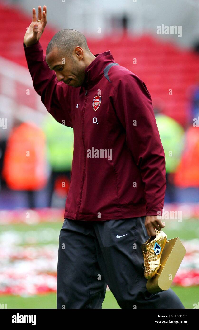 Arsenal's Thierry Henry waves as he leaves the pitch, carrying his Barclays  Premier League Golden Boot trophy as this season's top goal scorer,  following farewell celebrations at Highbury May 7, 2006. Arsenal