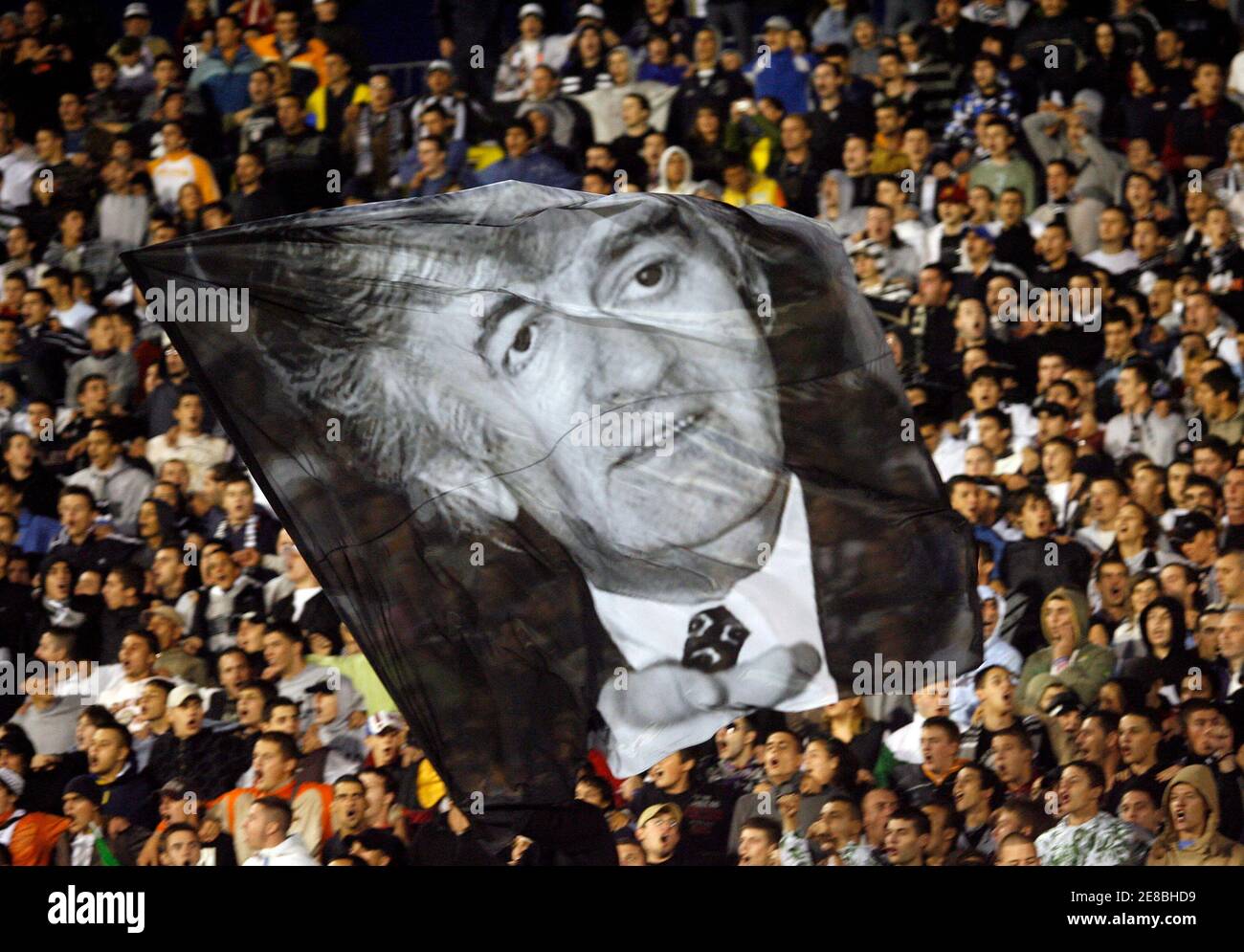 Supporters of Partizan Belgrade wave flag with Radovan Karadzic's picture during friendly soccer match against Olympique Lyonnais in Belgrade July 23, 2008.   REUTERS/Ivan Milutinovic (SERBIA)  BEST QUALITY AVAILABLE Stock Photo