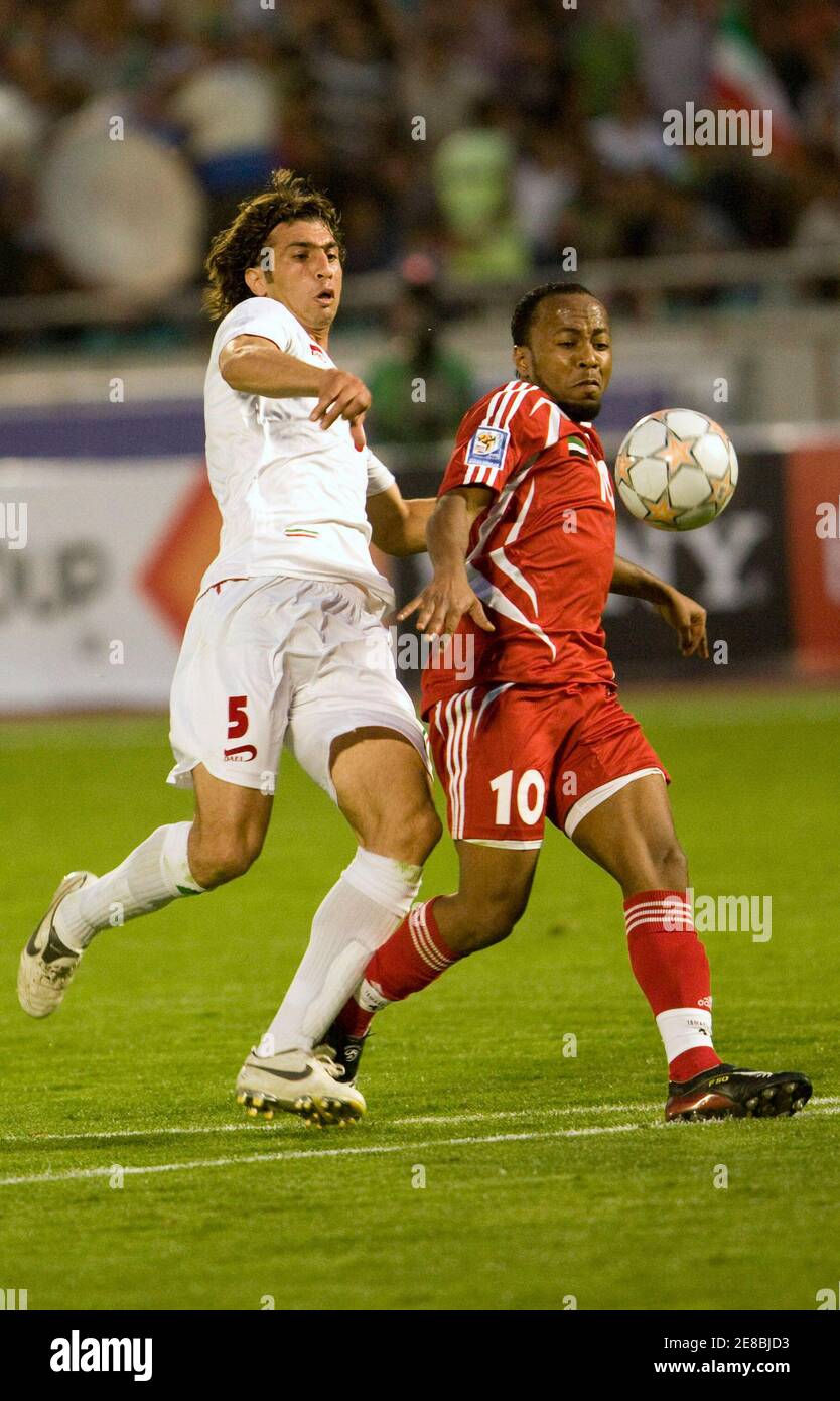Ismaeil Matar Ibrahim al-Junaibi (R) of United Arab Emirates fights for the ball with Iran's Seyed Hadi Aghily Anvar during their World Cup 2010 qualifying soccer match in Tehran June 2, 2008. REUTERS/Raheb Homavandi(IRAN) Stock Photo