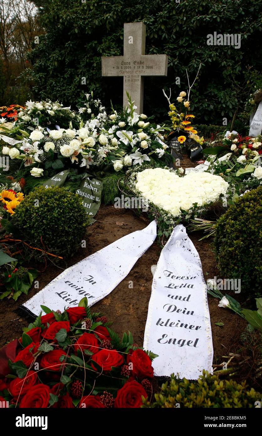 The grave of Germany's national goalkeeper Robert Enke and his daughter  Lara is covered with flowers at the graveyard of the small village of  Empede near Hannover November 16, 2009. Goalkeeper Enke,