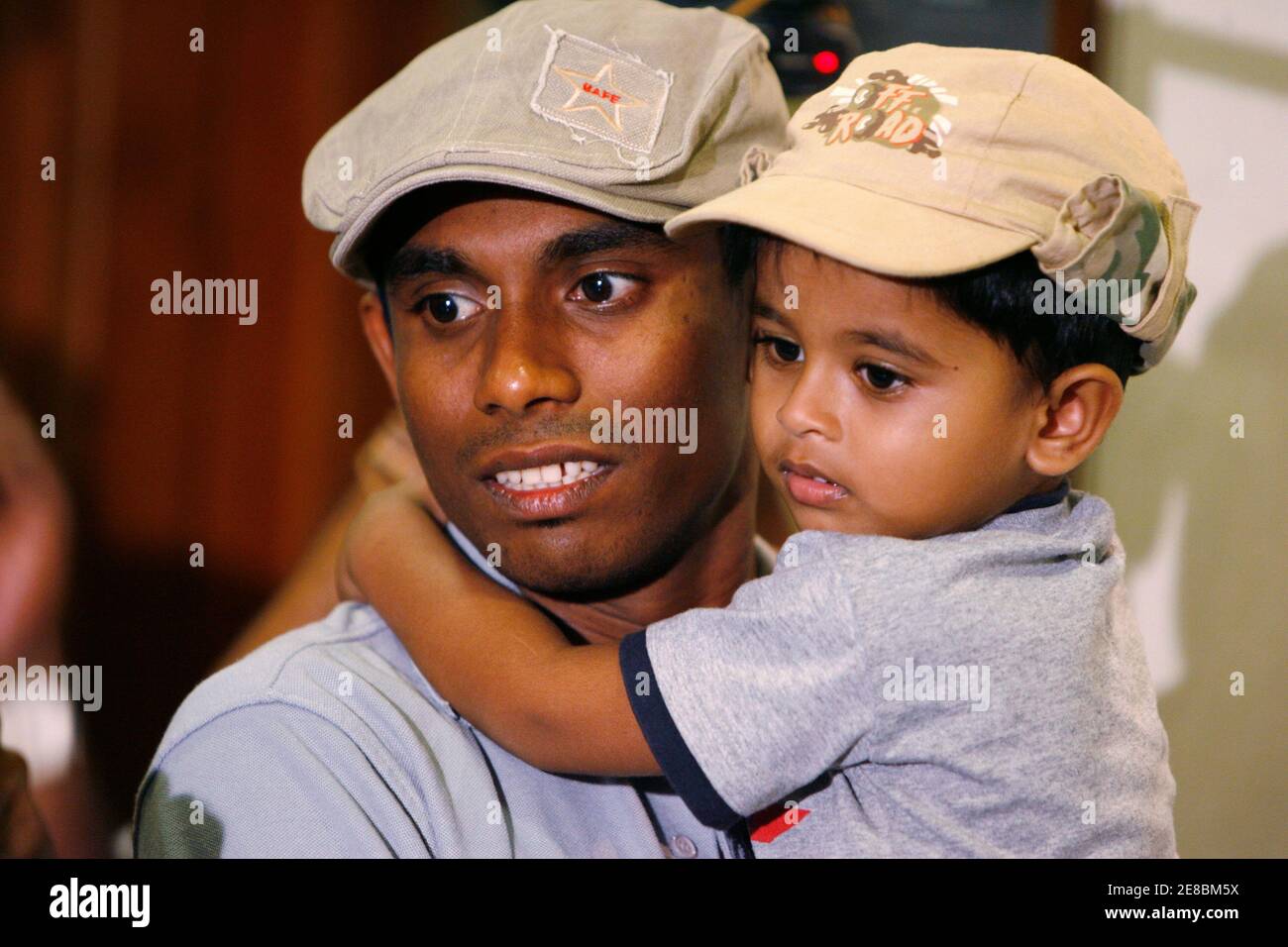 Thilan Thushara, a member of the Sri Lankan cricket team, holds his son as he arrives at Colombo airport in Sri Lanka, after the attack against his team yesterday morning in Pakistan March 4, 2009. Pakistani police hunted on Wednesday for the gunmen who mounted a bold attack on Sri Lanka's cricket team in Lahore and officials scrambled to figure out who was behind it. The attack killed eight people, six of them Pakistani police. Six members of the Sri Lankan team and a British coach were wounded in the daylight attack as their bus approached the cricket stadium.      REUTERS/Nir Elias (SRI LAN Stock Photo