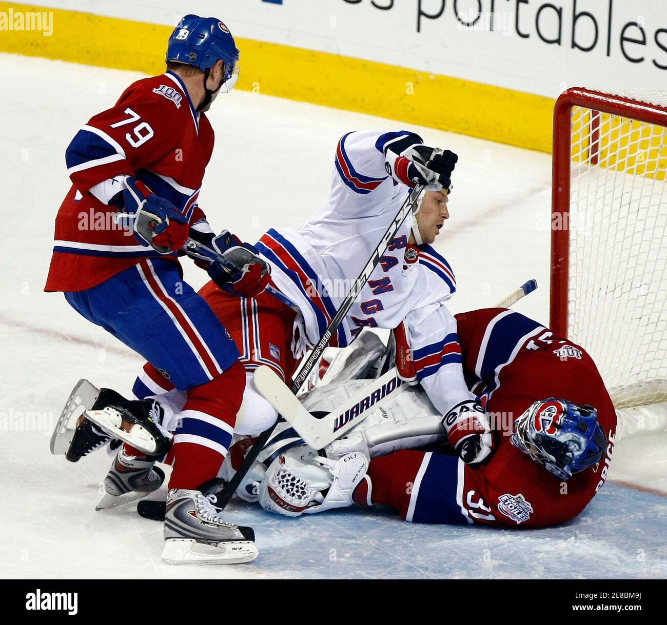 New York Rangers Sean Avery (C) collides with Montreal Canadiens goaltender Carey Price (31), as Canadiens' Andrei Markov (79) skates in, during first period NHL hockey action in Montreal March 17, 2009.  REUTERS/Christinne Muschi (CANADA SPORT ICE HOCKEY) Stock Photo