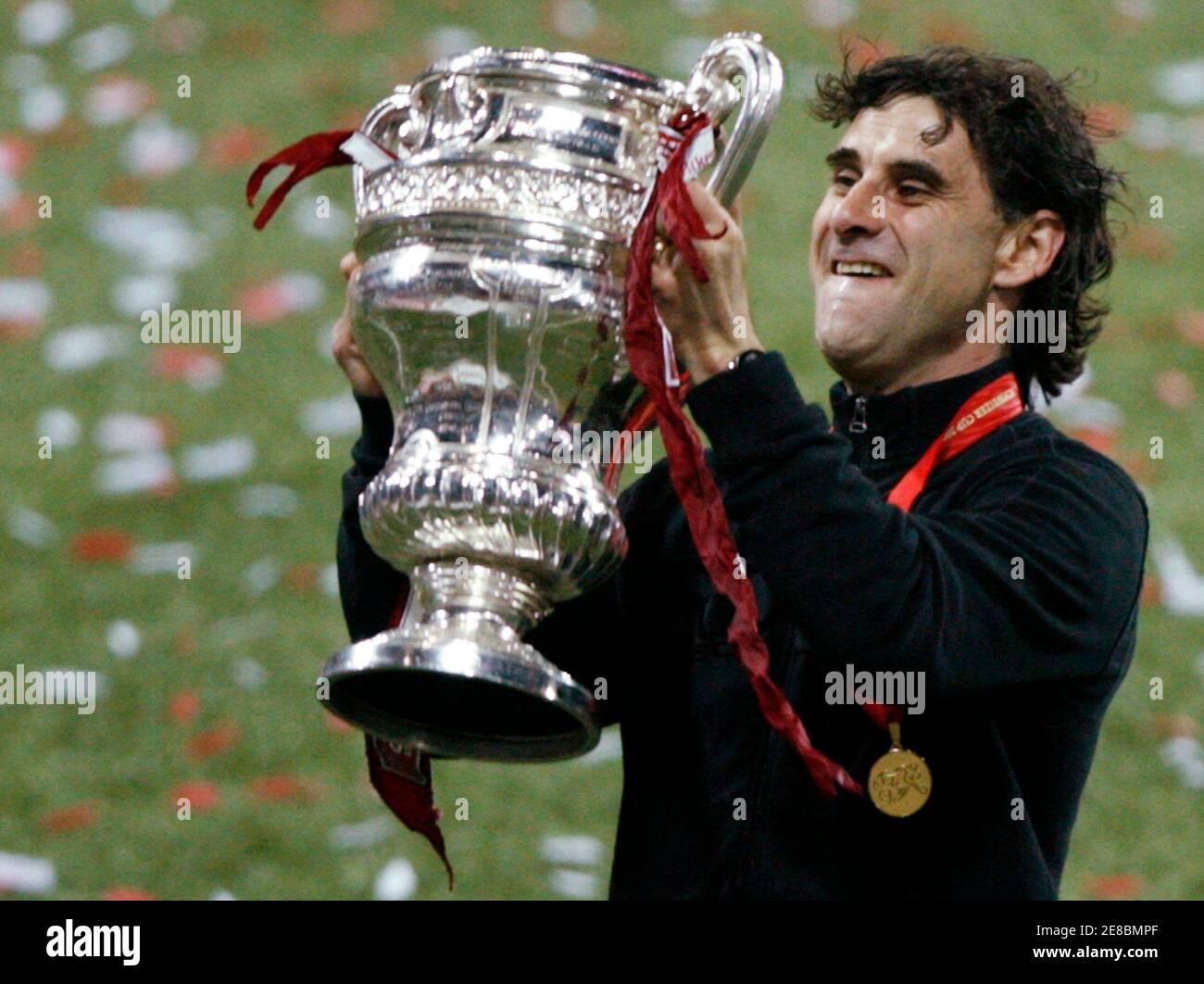 FC Sion's coach Didier Tholot raises his team's Swiss Cup trophy after  winning the Swiss Cup final soccer match against BSC Young Boys (YB) in  Bern May 20, 2009. REUTERS/Denis Balibouse (SWITZERLAND
