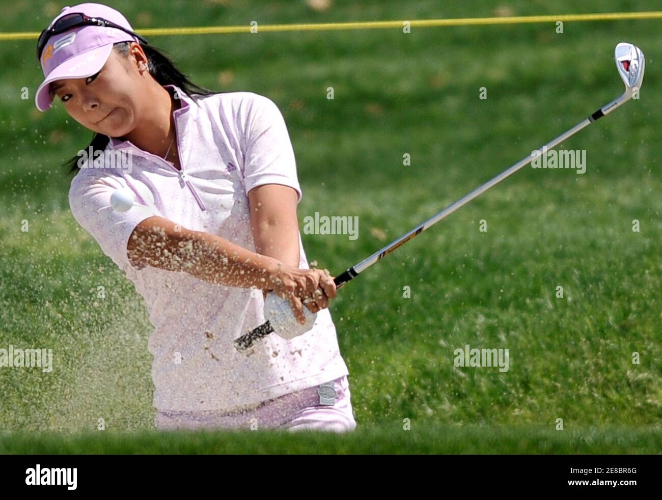 Yuko Mitsuka, of Japan hits from the bunker onto the green at the second hole during the third round of the LPGA's Kraft Nabisco Women's golf championship in Rancho Mirage, California April 3, 2010.  REUTERS/Gus Ruelas (UNITED STATES - Tags: SPORT GOLF) Stock Photo