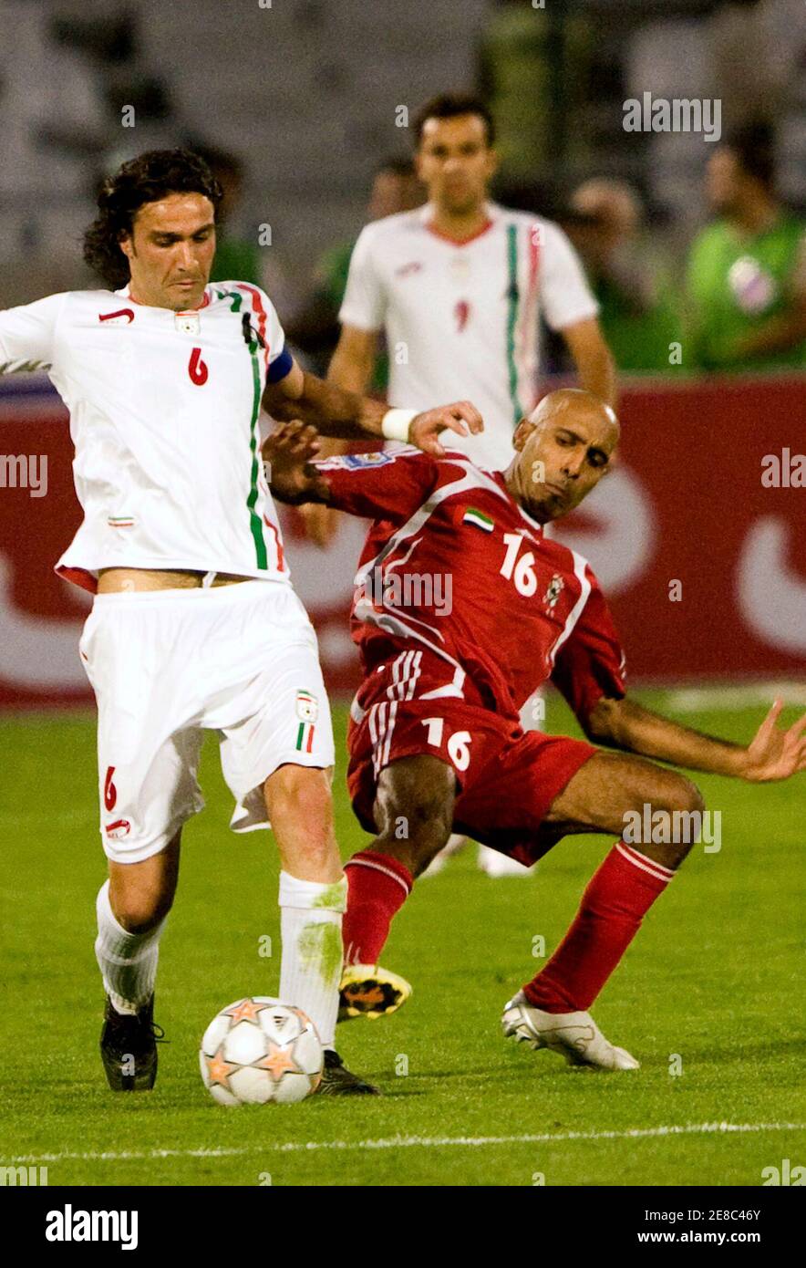 Iran's Javad Nekounam (L) fights for the ball with Helal Saeed Humaid al-Saedi of United Arab Emirates during their World Cup 2010 qualifying soccer match in Tehran June 2, 2008. REUTERS/Raheb Homavandi (IRAN) Stock Photo