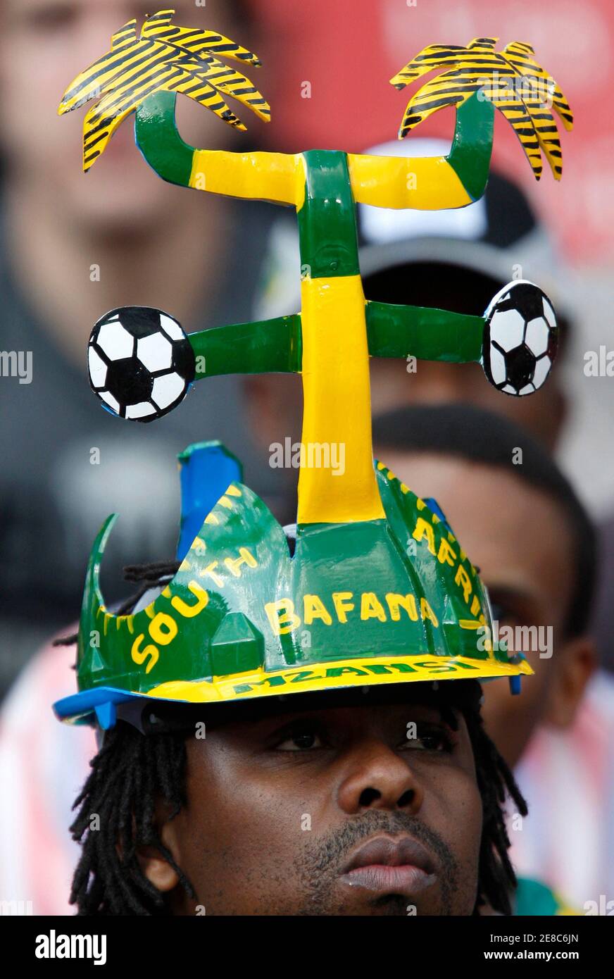 A soccer fan wears a funny hat, also 