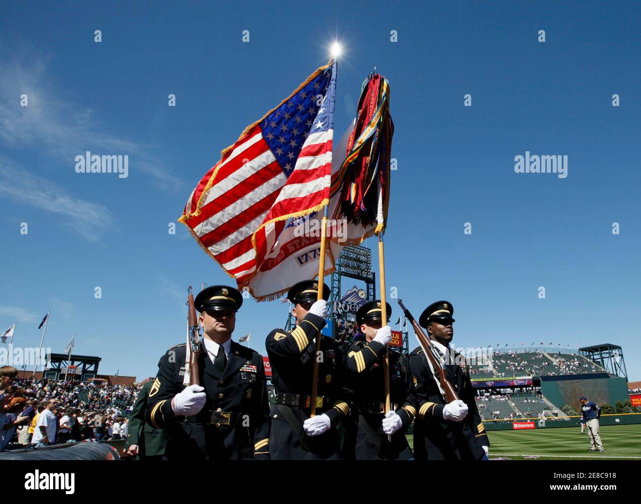 The color guard takes the field before the MLB baseball game between the Colorado Rockies and San Diego Padres in Denver April 9, 2010. REUTERS/Rick Wilking (UNITED STATES - Tags: SPORT BASEBALL) Stock Photo