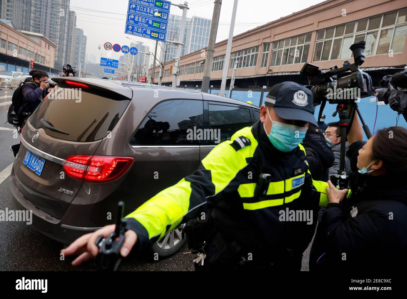 A car carrying members of the World Health Organization (WHO) team tasked with investigating the origins of the coronavirus disease (COVID-19) arrives at Huanan seafood market in Wuhan, Hubei province, China January 31, 2021. REUTERS/Thomas Peter Stock Photo