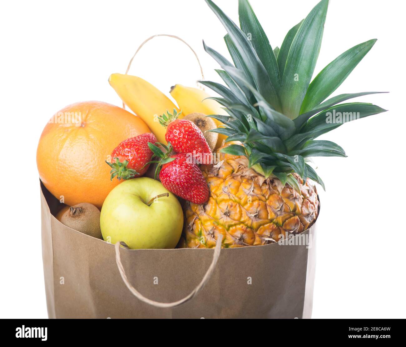 Fruits and vegetables in paper grocery bag isolated over white ...