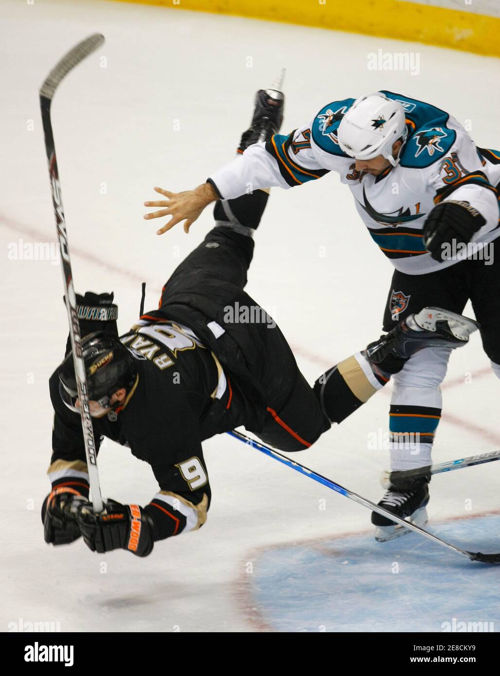 Anaheim Ducks right wing Bobby Ryan is hit to the ice by San Jose Sharks defenseman Brad Lukowich during the first period of Game 4 of the NHL Western Conference hockey playoffs in Anaheim, California April 23, 2009.   REUTERS/Mike Blake  (UNITED STATES SPORT ICE HOCKEY) Stock Photo