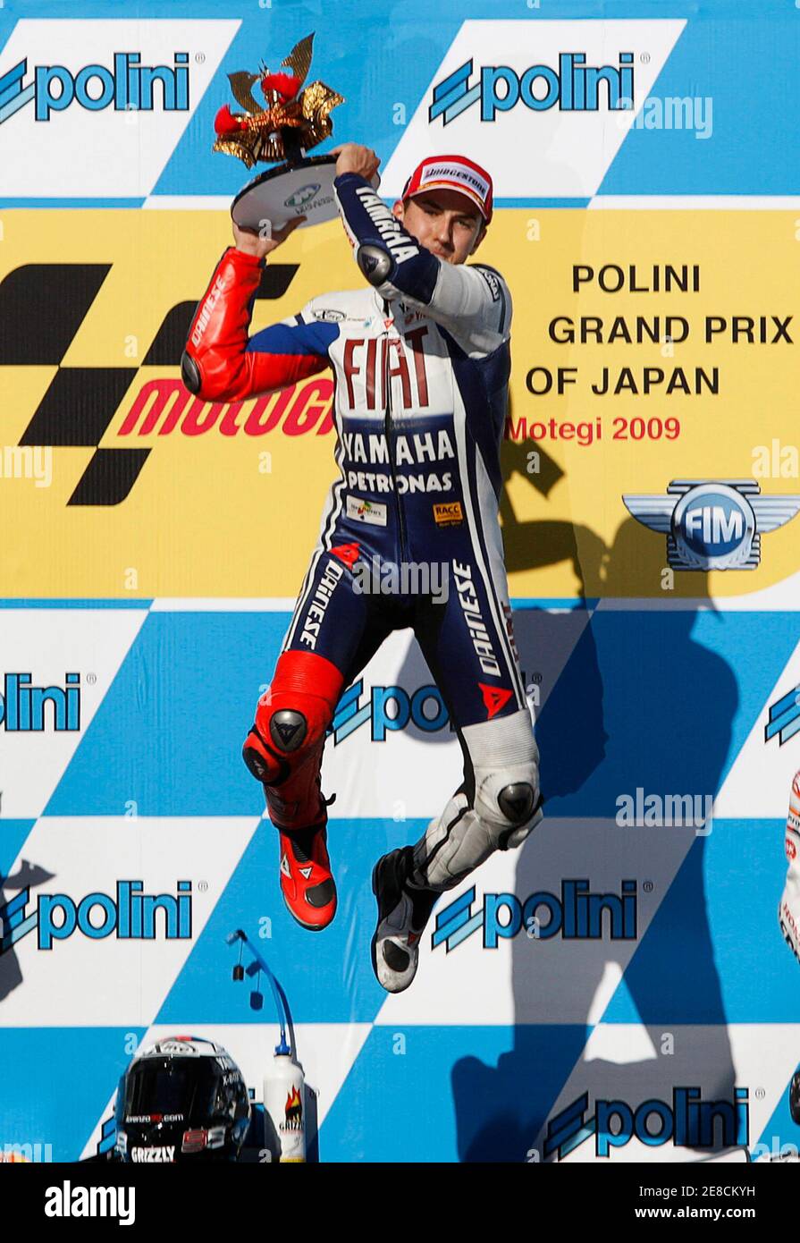 Yamaha MotoGP rider Jorge Lorenzo (C) of Spain jumps as he celebrates his  victory on the podium after the final of the Japanese Grand Prix in Motegi,  north of Tokyo April 26,