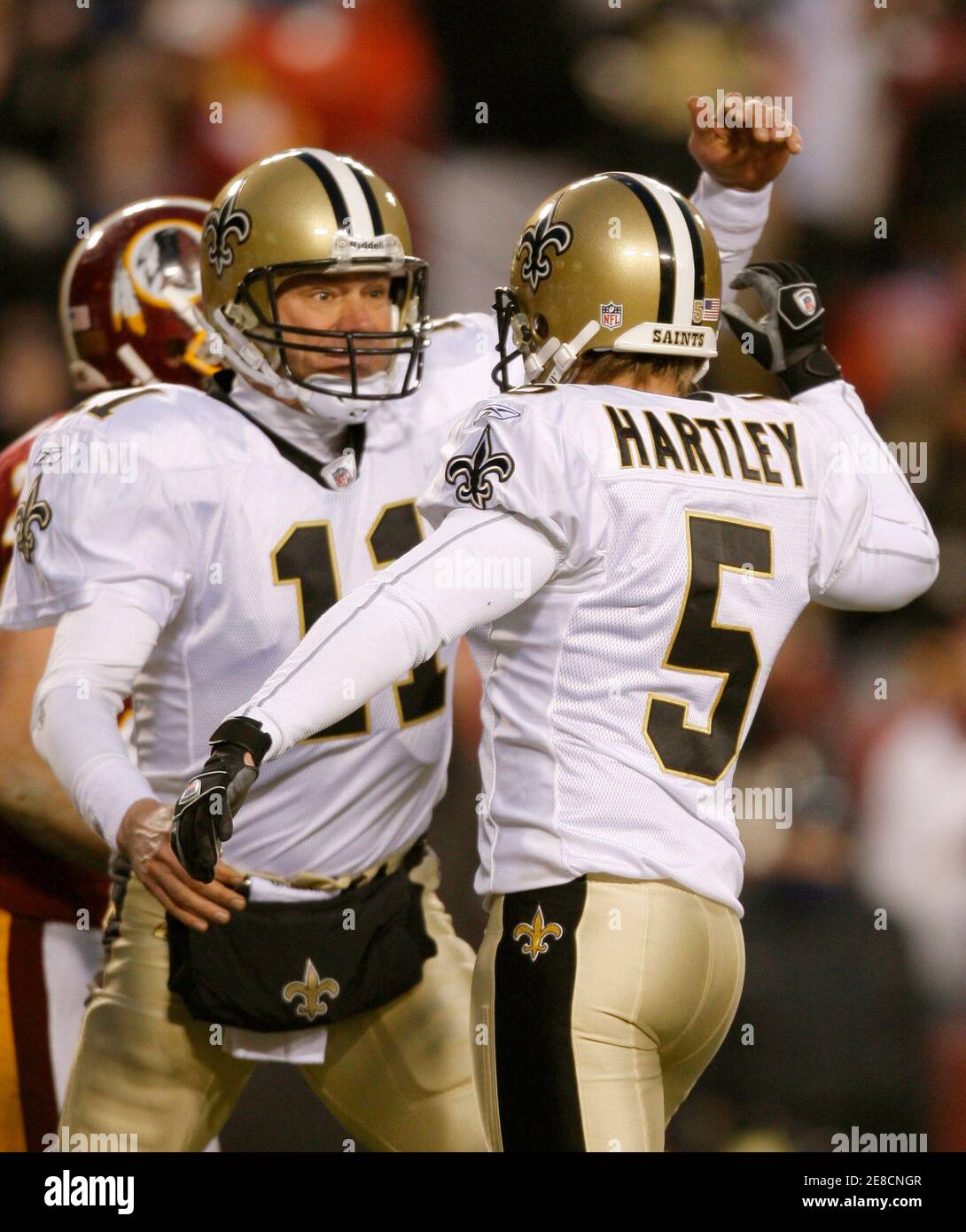 New Orleans Saints holder Mark Brunell (L) celebrates with Saints' kicker Garrett Hartley (5) after Hartley kicked the game-winning field goal against the Washington Redskins in overtime of their NFL football game in Landover, Maryland December 6, 2009.    REUTERS/Gary Cameron               (UNITED STATES SPORT FOOTBALL) Stock Photo