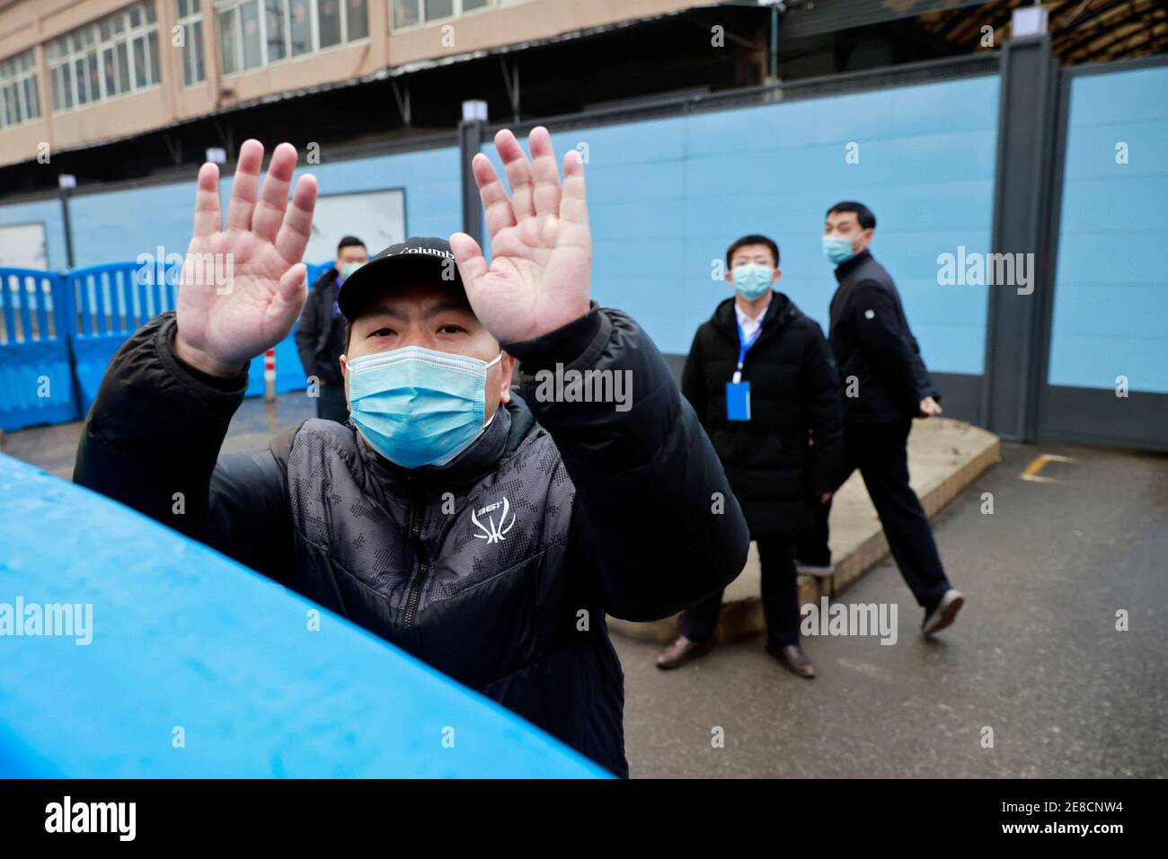 Security personnel secure the gate to Huanan seafood market during the visit by the World Health Organization (WHO) team tasked with investigating the origins of the coronavirus disease (COVID-19), in Wuhan, Hubei province, China January 31, 2021. REUTERS/Thomas Peter Stock Photo