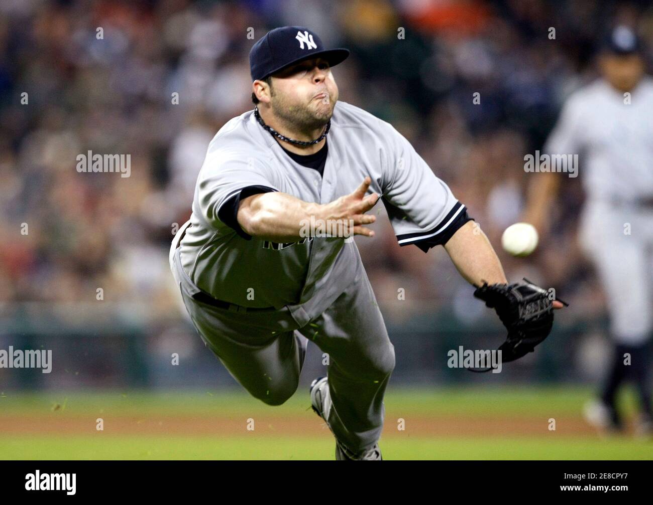 New York Yankees relief pitcher Joba Chamberlain is late on the throw to first after Detroit Tigers Austin Jackson singled to the pitcher during the eighth inning of game 2 of their double-header MLB baseball game in Detroit, Michigan May 12, 2010.  REUTERS/Rebecca Cook   (UNITED STATES - Tags: SPORT BASEBALL) Stock Photo