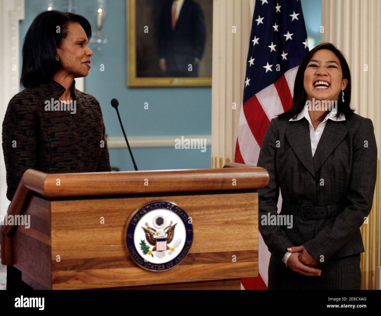Figure skating champion Michelle Kwan (R) laughs as U.S. Secretary of State Condoleezza Rice speaks at the Treaty Room of the State Department in Washington November 9, 2006. Rice named Kwan the public diplomacy ambassador to represent American values especially to young people and sports enthusiasts. REUTERS/Yuri Gripas  (UNITED STATES) Stock Photo
