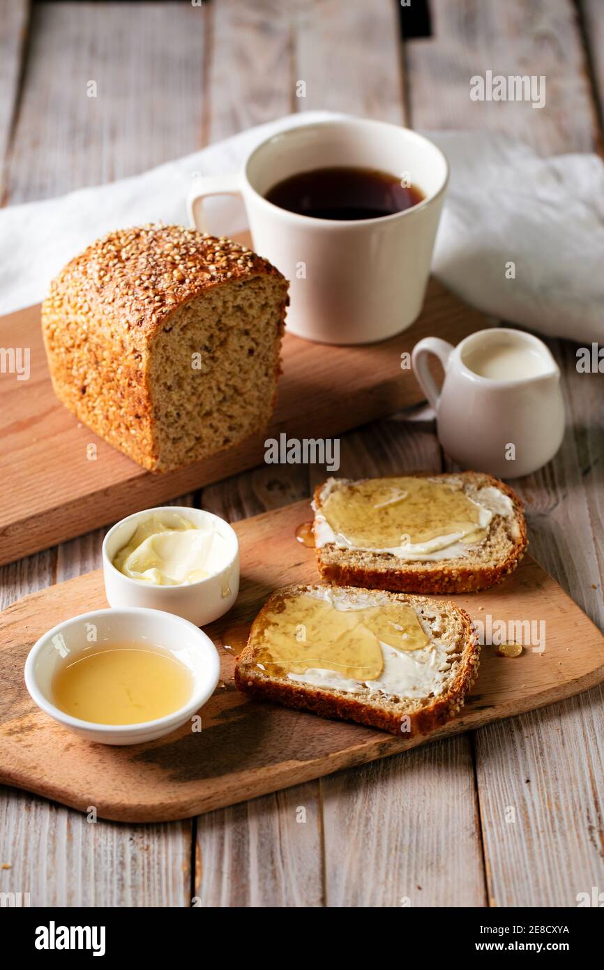Whole grain bread slices with butter and honey Stock Photo