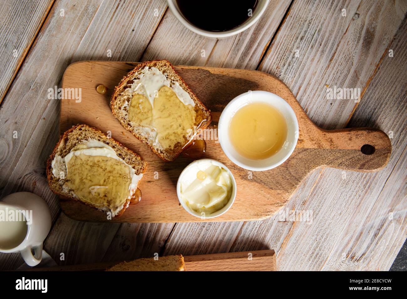 Whole grain bread slices with butter and honey Stock Photo - Alamy