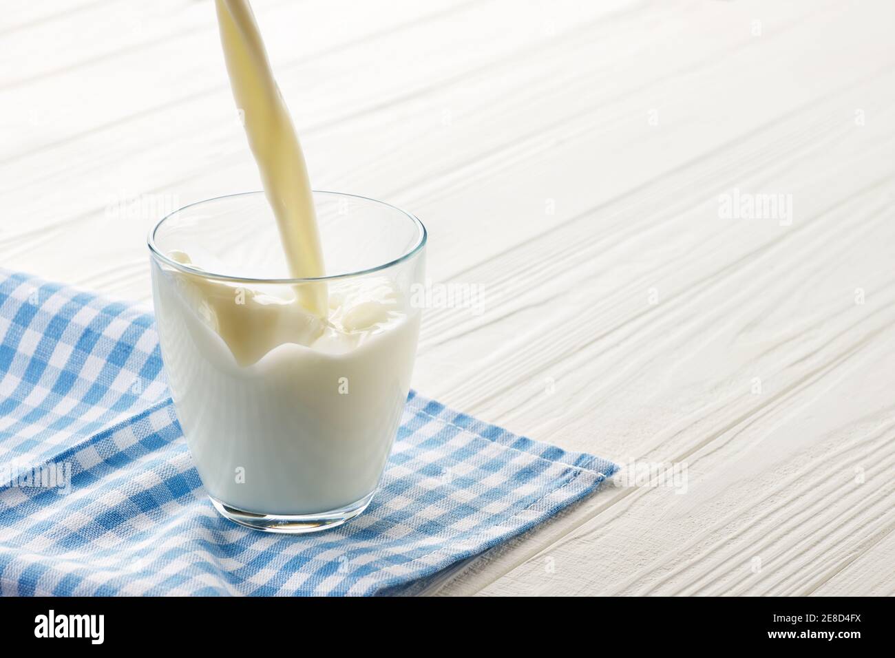 milk pouring into glass Stock Photo