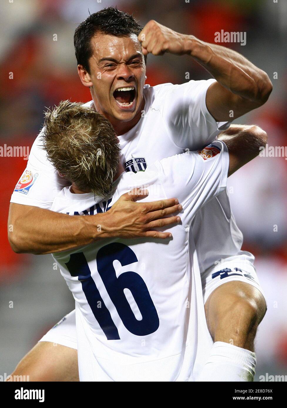 Auckland City's Adam Dickinson (top) celebrates his goal with teammate Jason Hayne during their FIFA Club World Cup soccer match against Al Ahli at Mohammad Bin Zayed stadium in Abu Dhabi December 9, 2009.  REUTERS/Fahad Shadeed (UNITED ARAB EMIRATES SPORT SOCCER) Stock Photo