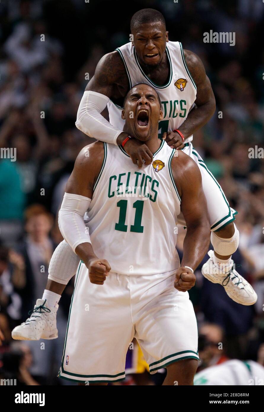 Boston Celtics guard Nate Robinson jumps on the back of Boston Celtics  forward Glen Davis after Davis scored and was fouled in the fourth quarter  during Game 4 of the 2010 NBA