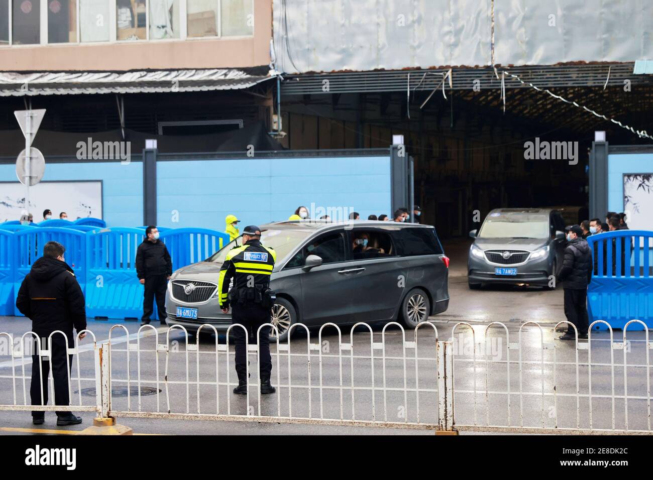 Cars carrying members of the World Health Organization (WHO) team tasked with investigating the origins of the coronavirus disease (COVID-19) leave Huanan seafood market in Wuhan, Hubei province, China January 31, 2021. REUTERS/Thomas Peter Stock Photo