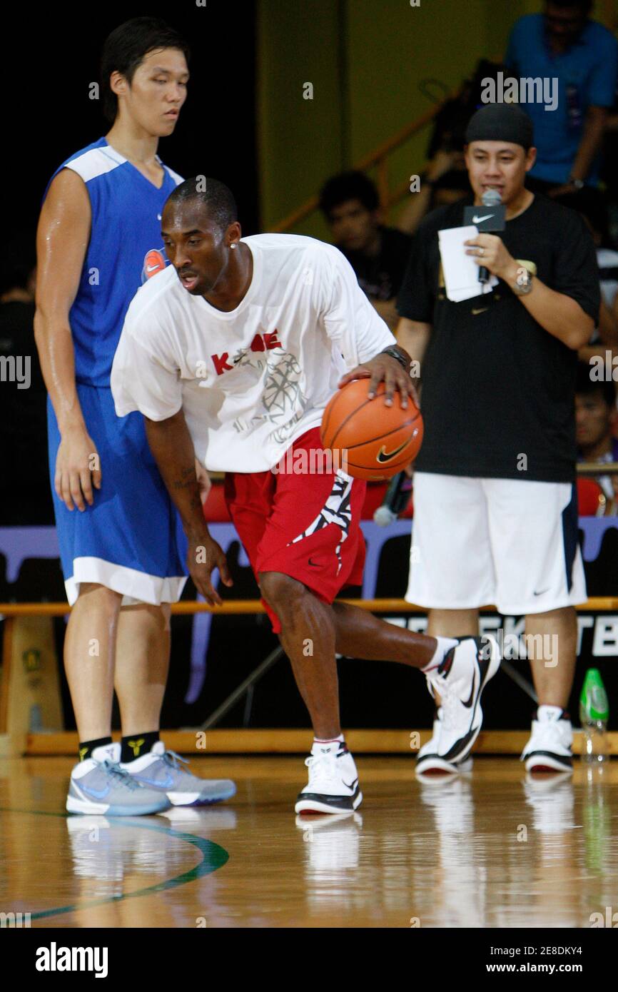 NBA basketball player Kobe Bryant of the Los Angeles Lakers teaches young local players basketball skills during a promotional event in Hong Kong July 24, 2009. Bryant was in Hong Kong as part of his Asia tour.  REUTERS/Tyrone Siu    (CHINA SPORT BASKETBALL) Stock Photo