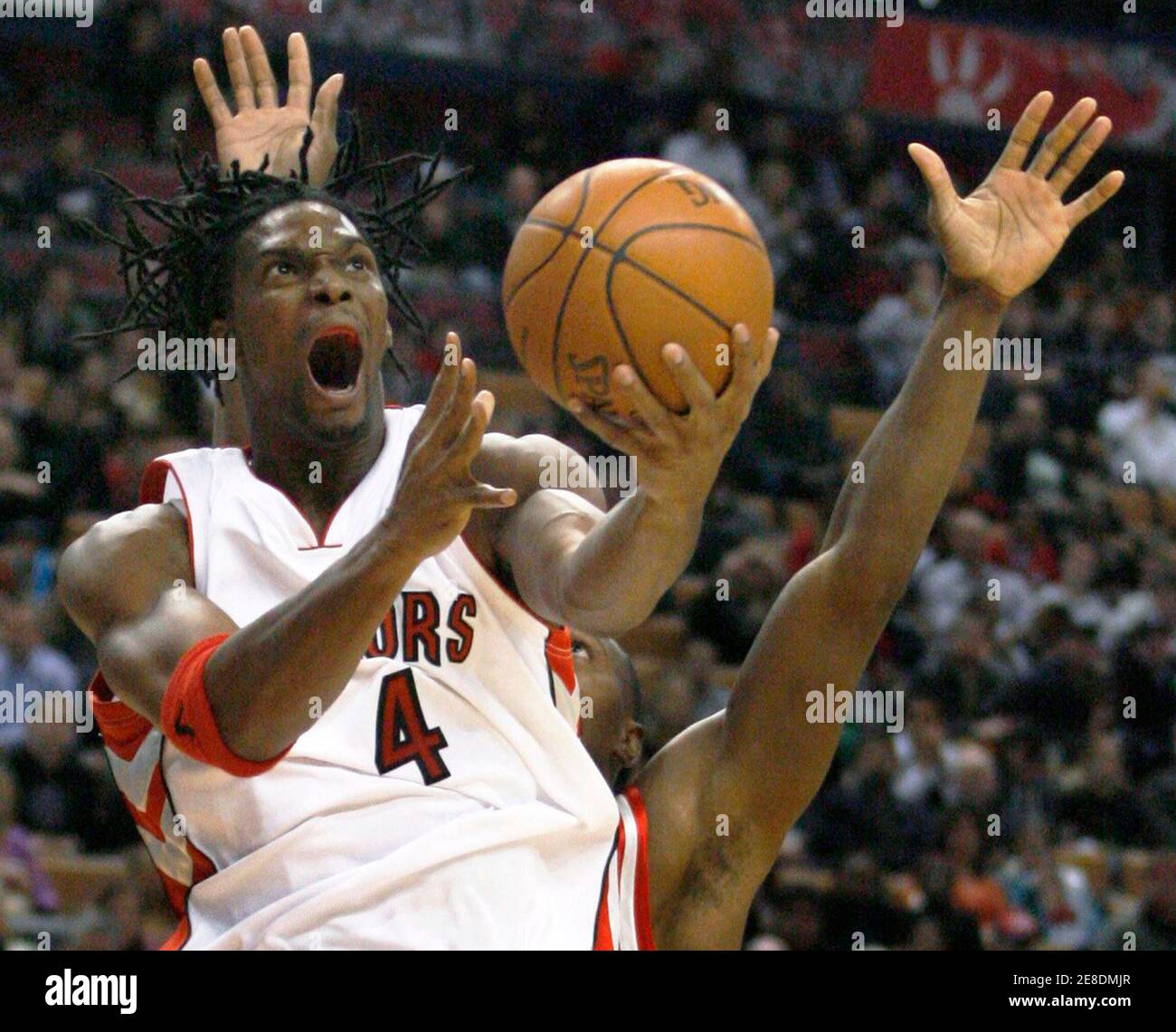 Toronto Raptors forward Chris Bosh goes to the basket against the Houston  Rockets during the first half of their pre-season NBA basketball game in  Toronto in this October 15, 2009 file photo.