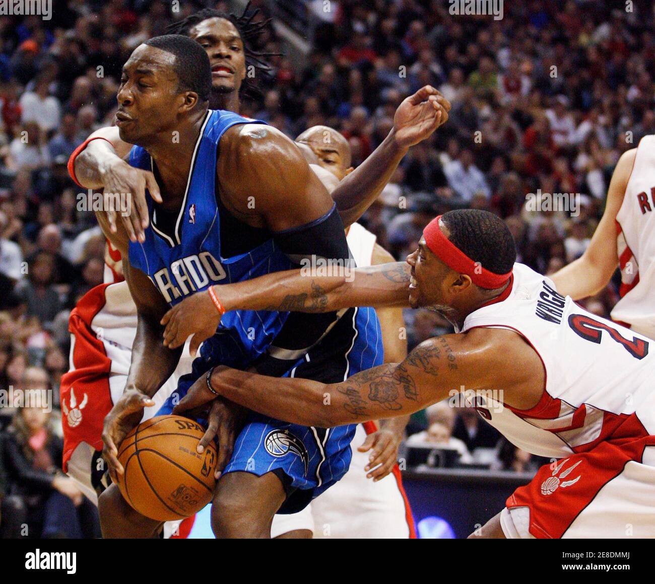 Orlando Magic center Dwight Howard (L) is double teamed by Toronto Raptors  forwards Chris Bosh and Antoine Wright (R) during the second half of their  NBA basketball game in Toronto November 1,