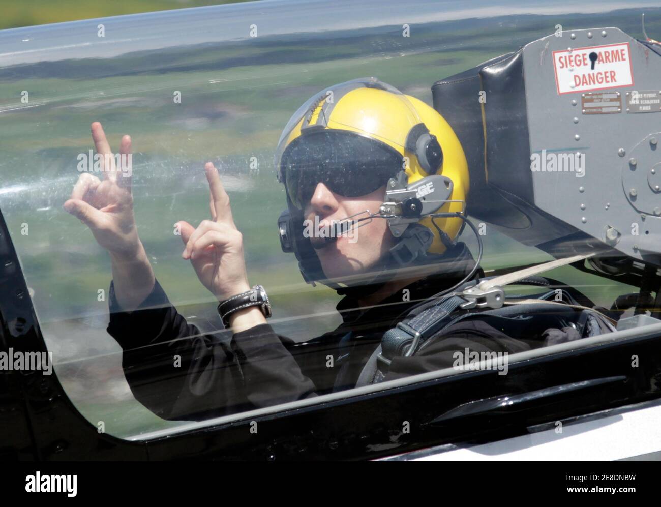 Four time Olympic ski jump winner Simon Ammann of Switzerland waves before  his flight with the Breitling Jet Team in Buochs May 11, 2010. Ammann has  become the ambassador of the Breitling