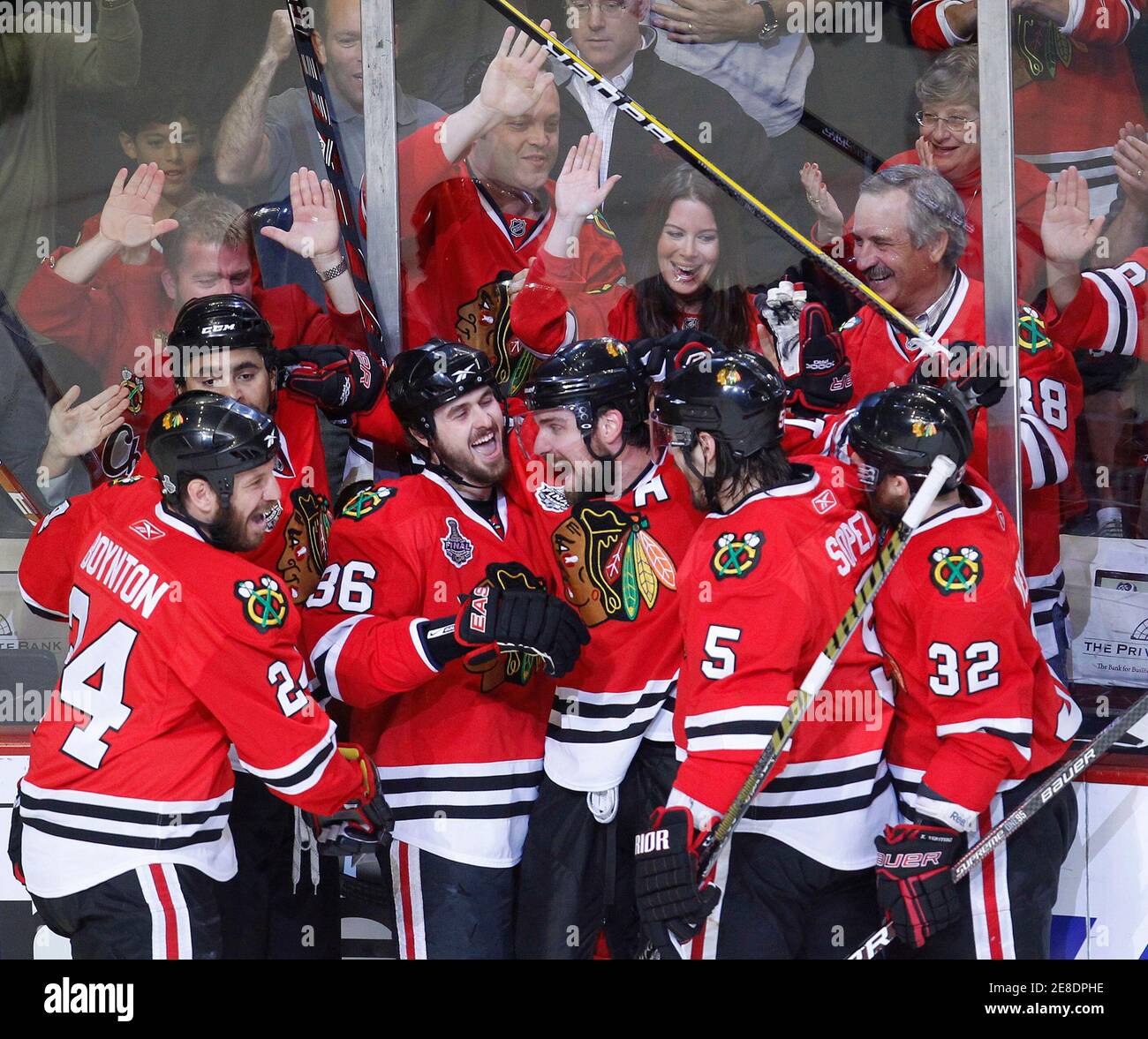 Actor Vince Vaughn and his wife Kyla Weber cheer in the background as  Chicago Blackhawks Dave Bolland (36) celebrates his goal with his teammates  in Game 5 of their NHL Stanley Cup