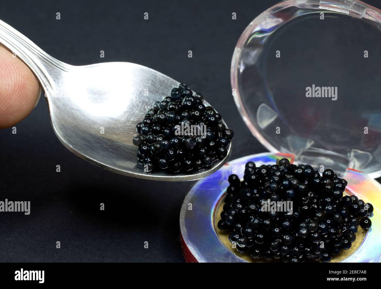 Caviar substitute, black lump roe in a spoon Stock Photo