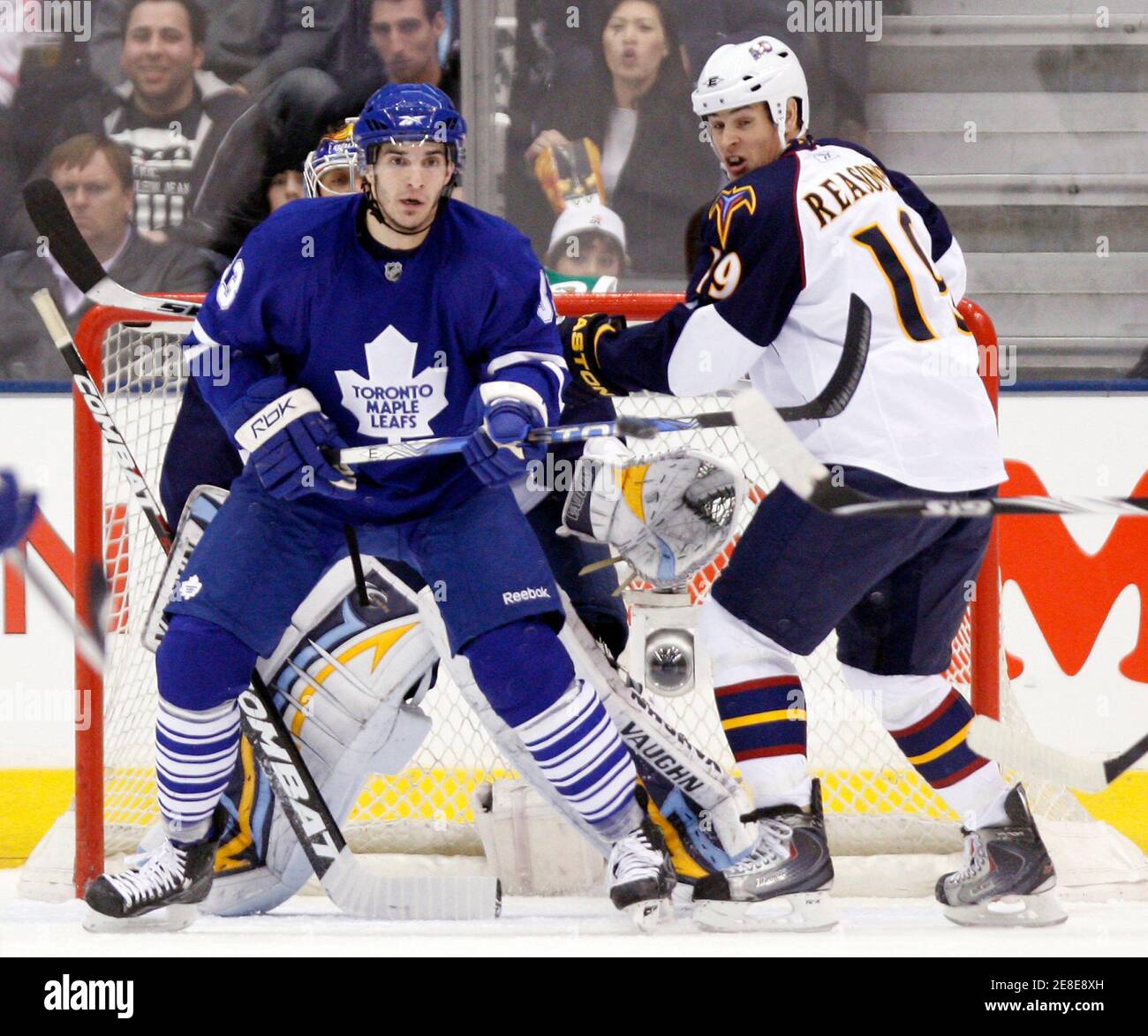 Toronto Maple Leafs Forward Luca Caputi C Tries To Deflect A Shot In Front Of Atlanta Thrashers Goalie Ondrej Pavelec And Forward Marty Reasoner R During The First Period Of Their Nhl