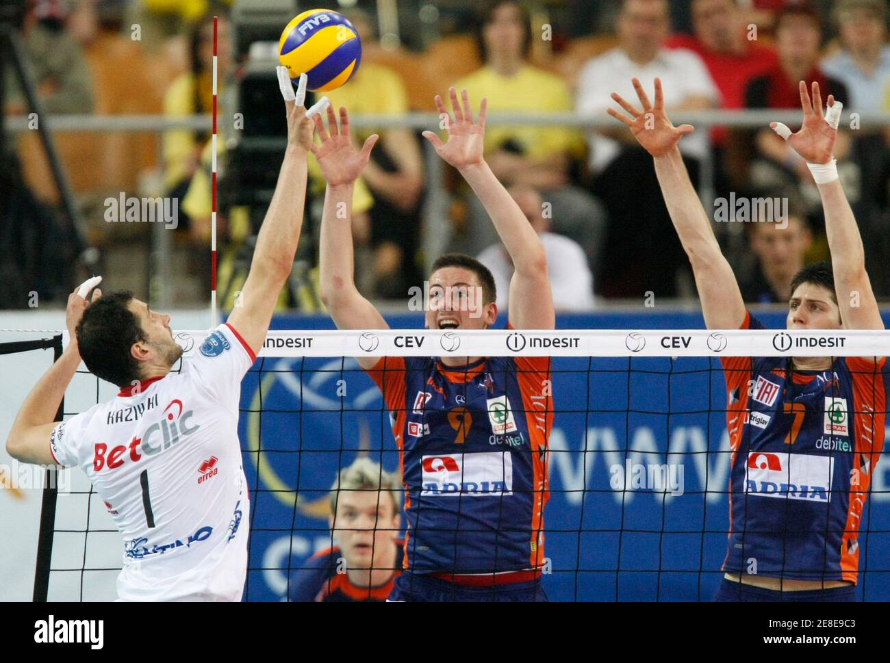 BetClic Trentino Matey Kaziyski spikes a ball against ACH Volley Bled Dejan  Vincic (L) and Matevz Kamnik during their CEV Indesit Champions League semi final  volleyball match in Lodz, May 1, 2010.