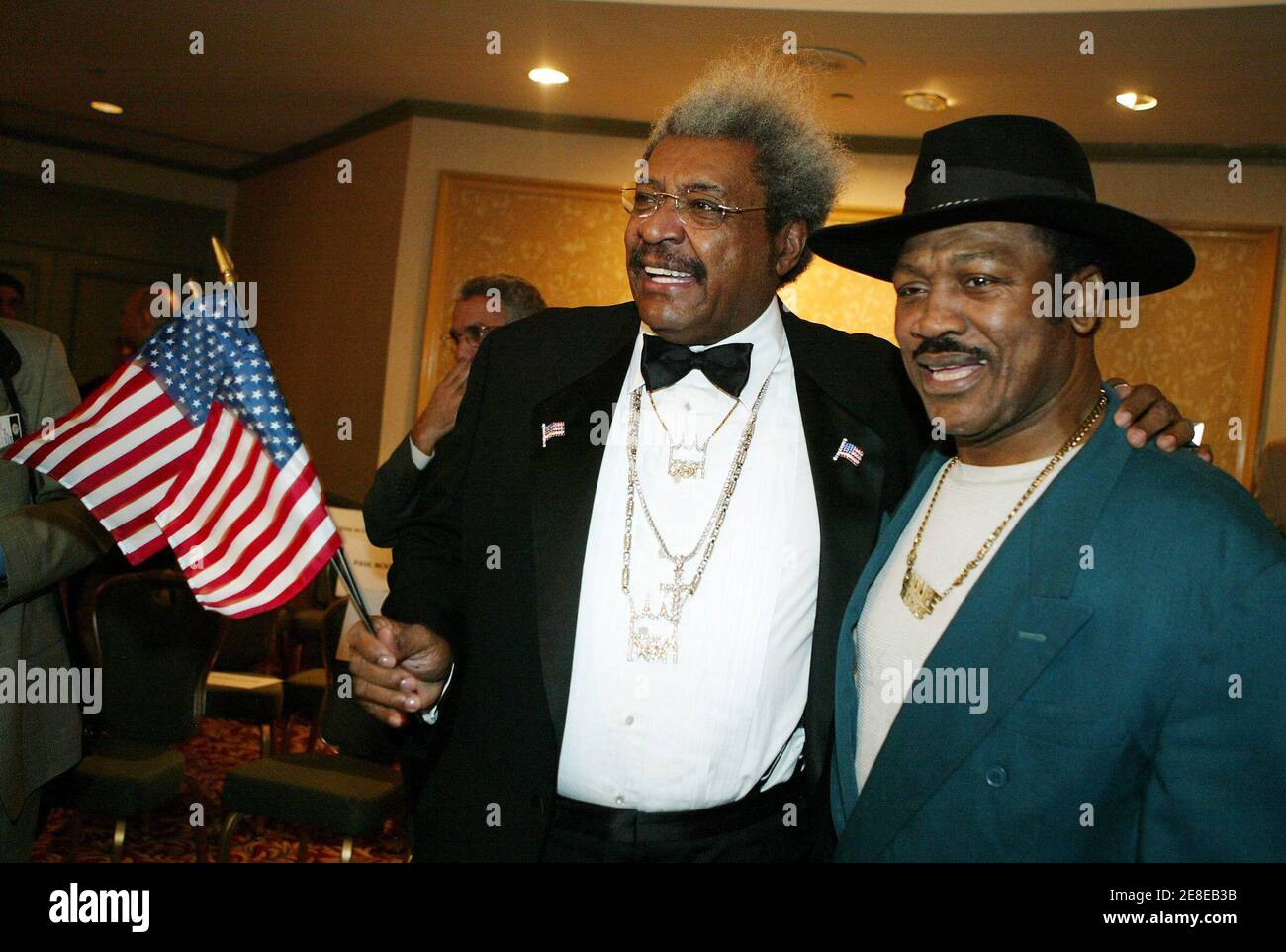 Boxing promoter Don King (L) and former heavywieght champion Joe Frazier  pose at a news conference in New York October 28, 2005. King has been  promoting boxing for more than 40 years.