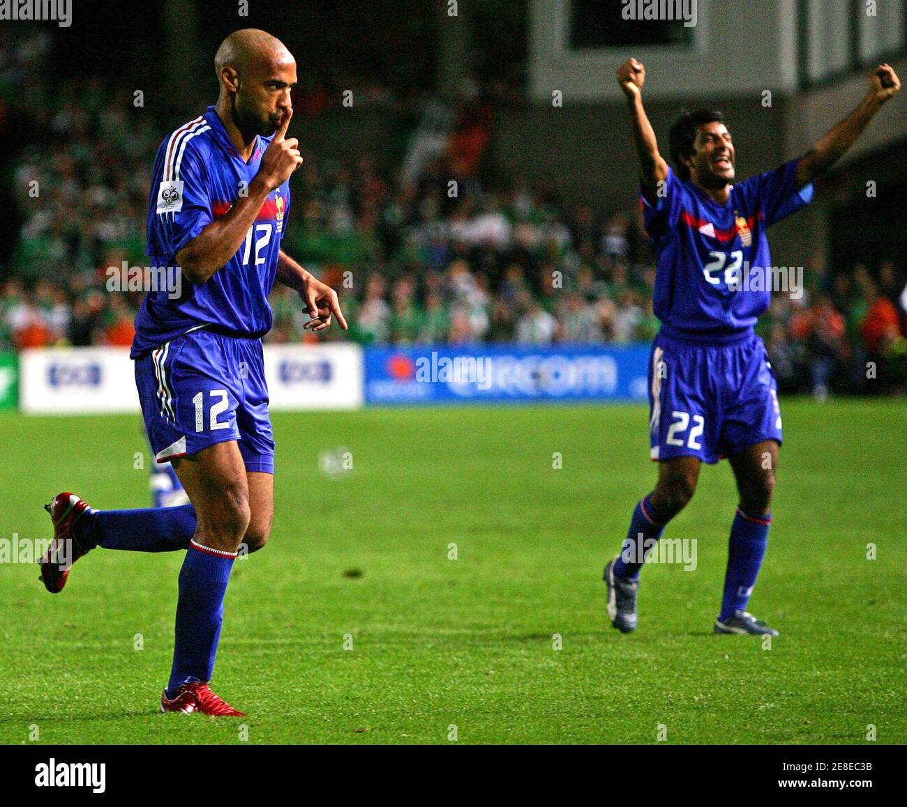 France's Henry celebrates goal with Dhorasoo during World Cup qualifying match against Ireland in Dublin.  France's Thierry Henry (L) celebrates his goal with Vikash Dhorasoo during their World Cup 2006, Group Four, qualifying soccer match against Ireland at Lansdowne Road in Dublin, September 7, 2005. REUTERS/Eddie Keogh Stock Photo