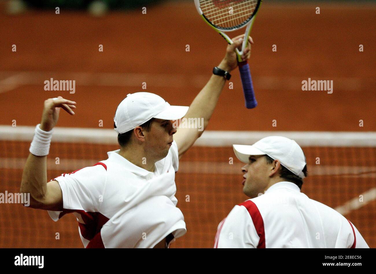 Twin brothers Mike (R) and Bob (L) Bryan of the U.S. celebrate after  winning a game against Belgium's Olivier Rochus and Kristof Vliegen of  Belgium during their Davis Cup World Group Play-offs