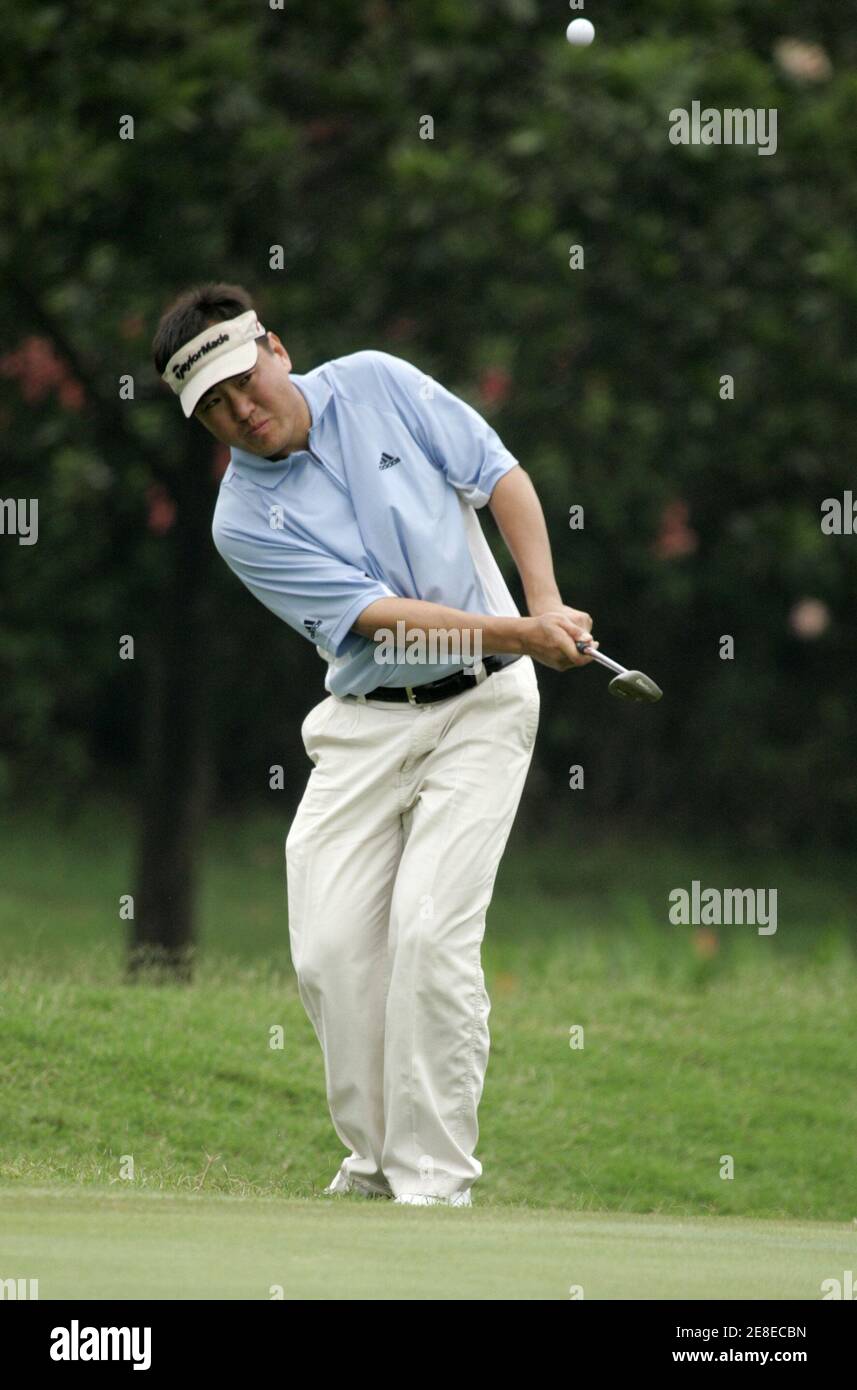 South Korea's Charlie Wi watches his shot on the twelfth hole during the second day of the Indonesia Open golf tournament in Cimanggis, West Java Province on March 3, 2006. REUTERS/Beawiharta Stock Photo
