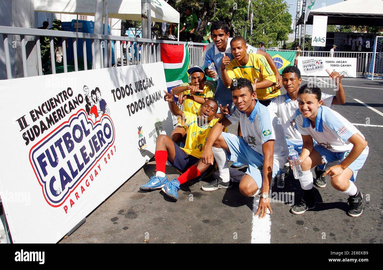 Players from Team Sudafrica and Brazil pose for a photo during the II South American Street Soccer meeting in the Paraguayan capital Asuncion December 1, 2007. The competition, which had youths from eleven countries participating, aims to promote participation and dialogue between children and youths by using football as a tool for promoting social integration and children's rights. REUTERSJorge Adorno (PARAGUAY) Stock Photo