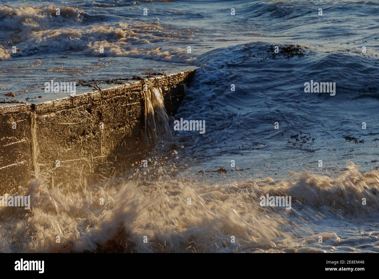 Waves lapping across the slipway Stock Photo