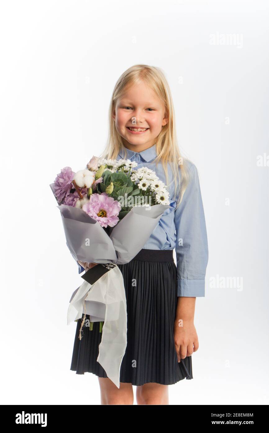 Studio portrait of cute blonde girl in school uniform with beautiful ...