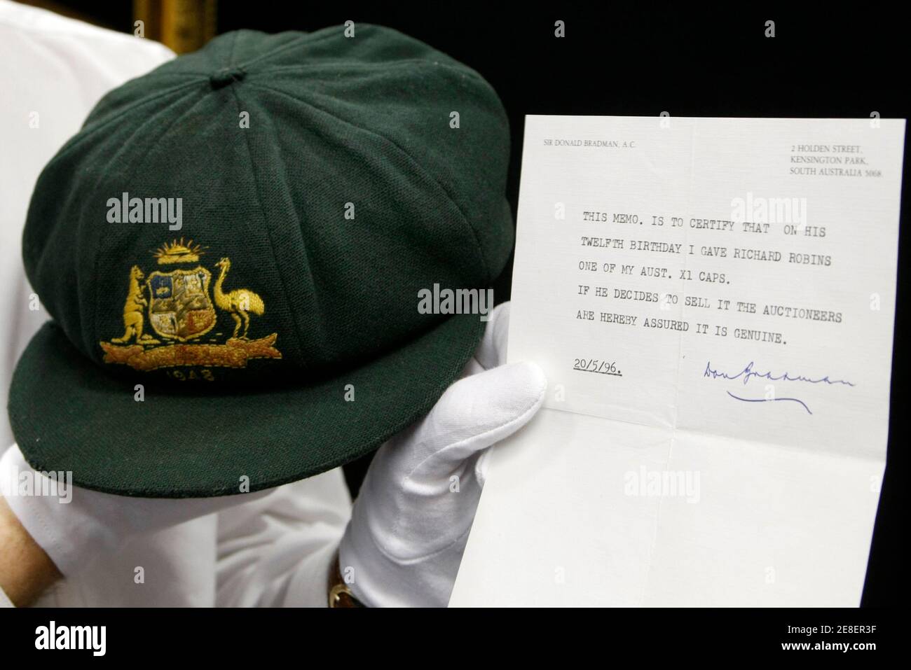 Auctioneer Charles Leski Holds Australia S Cricket Legend Sir Donald Bradman S Baggy Green 1948 Invincibles Test Match Cap With An Authentication Letter In Melbourne December 2 08 Bradman S Cap Will Be Auctioned On