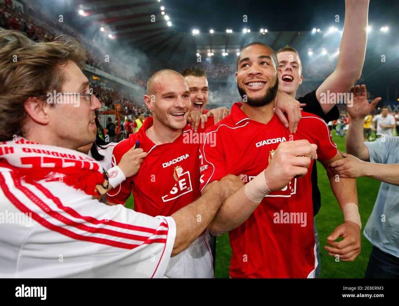 Standard Liege's Gucci Onyewu (R) celebrates with team mates after winning  the Belgian championship, after defeating Anderlecht in the second leg of  the Belgian soccer first division title playoff at the Sclessin