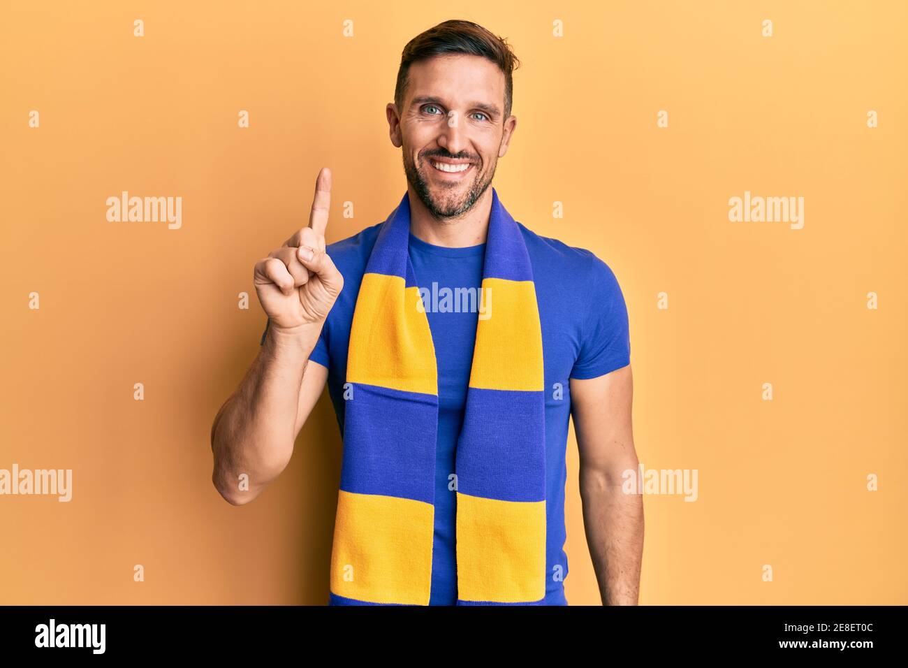 Number One Hooligans Handsome man with beard football hooligan cheering game smiling with an ...